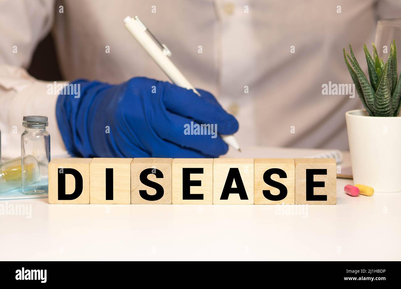 Krankheitswort aus Holzblöcken auf blauem Hintergrund Stockfoto