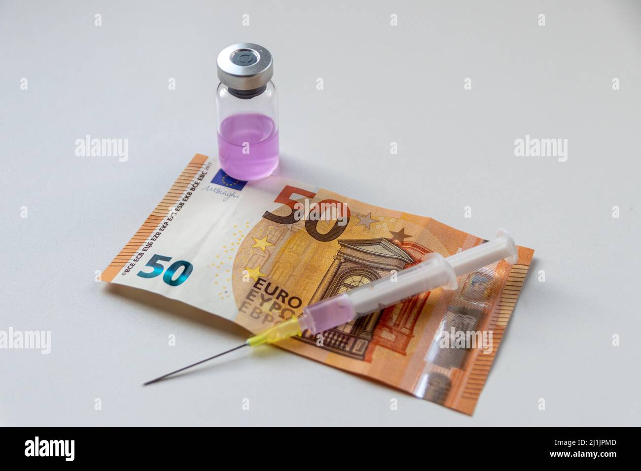 50 Euro Banknote und Injektionsspritze mit rosa medizinischen flüssigen Medizin warten auf einen reichen Patienten, um seine Krankheiten zu heilen, wenn viel Geld für die Gesundheit bezahlt Stockfoto