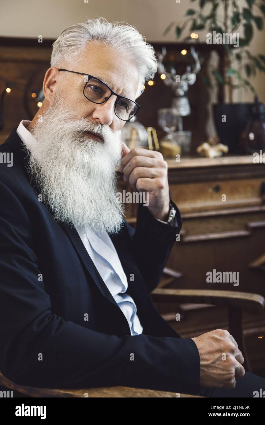 Gutaussehender bärtiger älterer Mann, der im Studio posiert Stockfoto