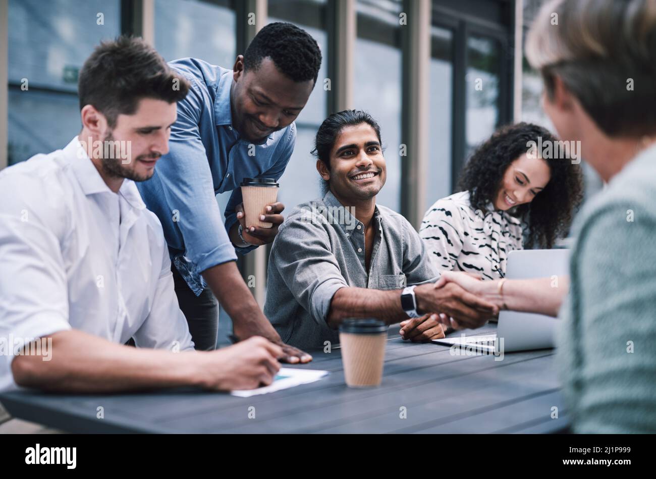 Gutes Geschäft basiert auf guten Beziehungen. Aufnahme eines Geschäftsmannes und einer Geschäftsfrau, die sich bei einem Treffen mit Kollegen die Hände schüttelten. Stockfoto