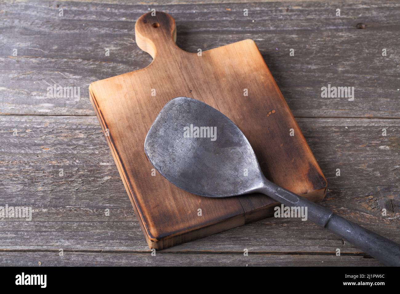 Küchengerät aus Metall auf Holzschneidplatte Stockfoto