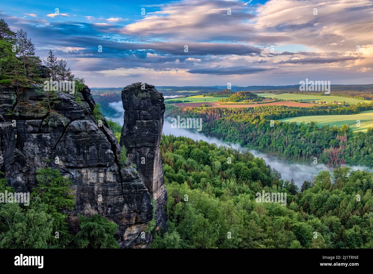 Landschaft mit Felsformationen und dem Gipfel Teufelsturm im Schmilka-Gebiet des Nationalparks Sächsische Schweiz bei Sonnenaufgang. Stockfoto