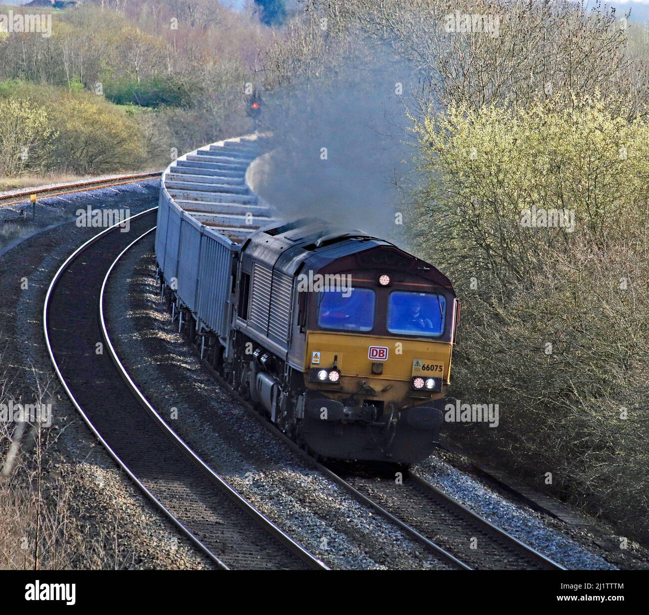 Die Diesellokomotive Nr. 66075 von D B Cargo legt einige klagige Abgase ab, während sie die Kurven zwischen Alfreton und Clay Cross in Derbyshire umrundet Stockfoto