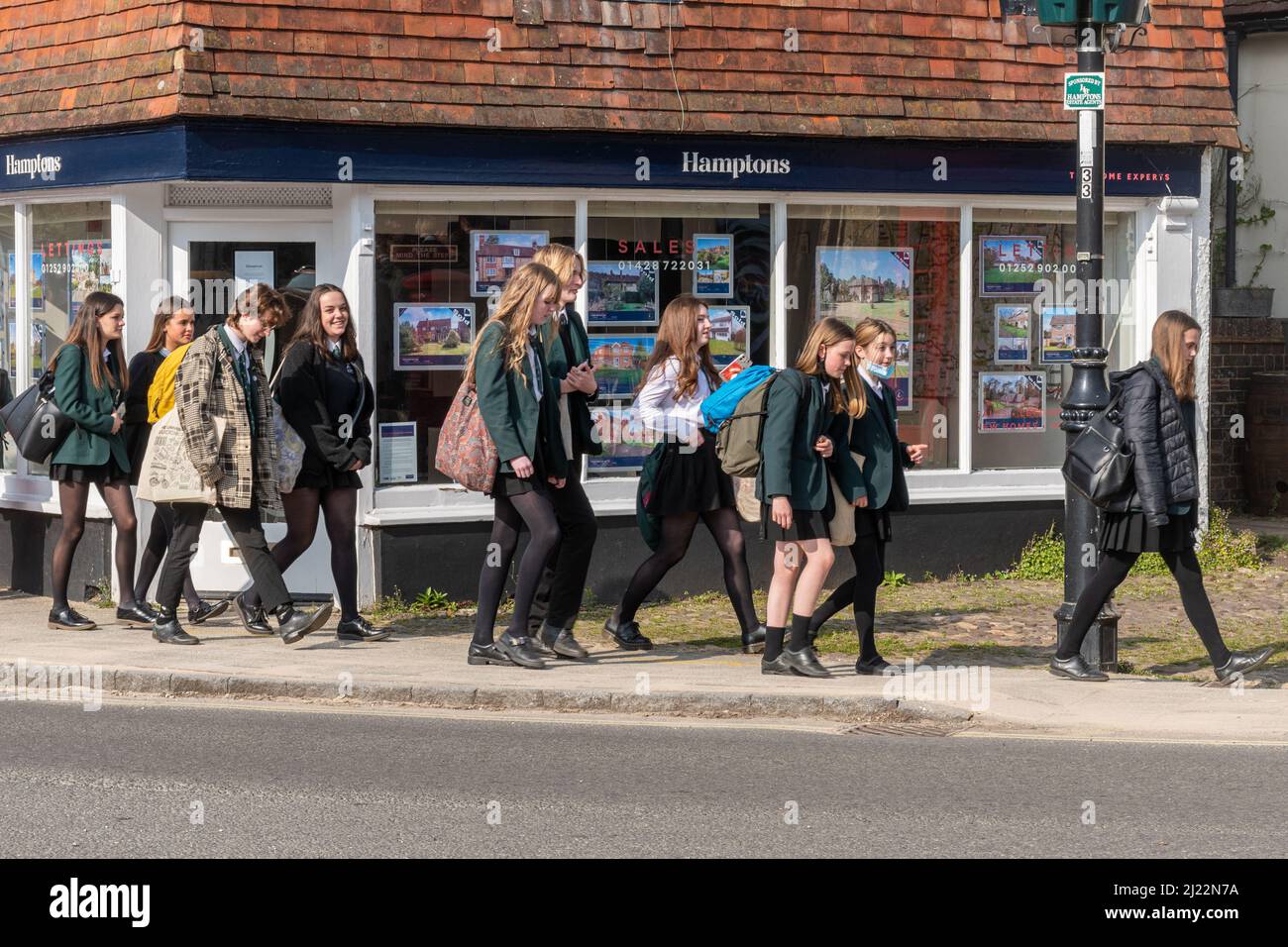 Sekundarschüler Schüler Schüler gehen nach der Schule durch das Liphook Center, Hampshire, England, Großbritannien Stockfoto