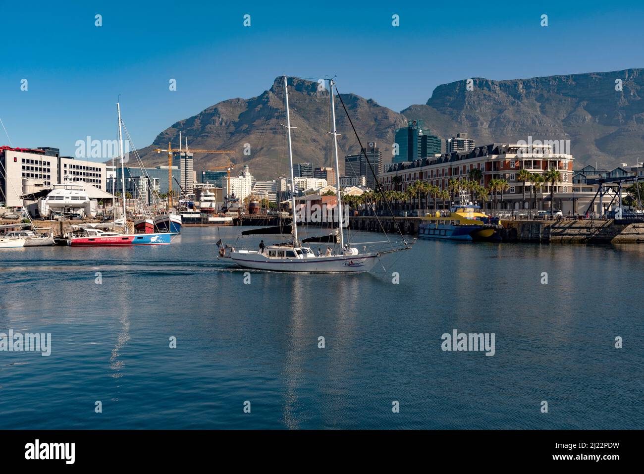 Kapstadt, Südafrika. 2022. Touristenfahrt Yacht durch den Hafen von Kapstadt mit Kulisse des Tafelbergs. Stockfoto