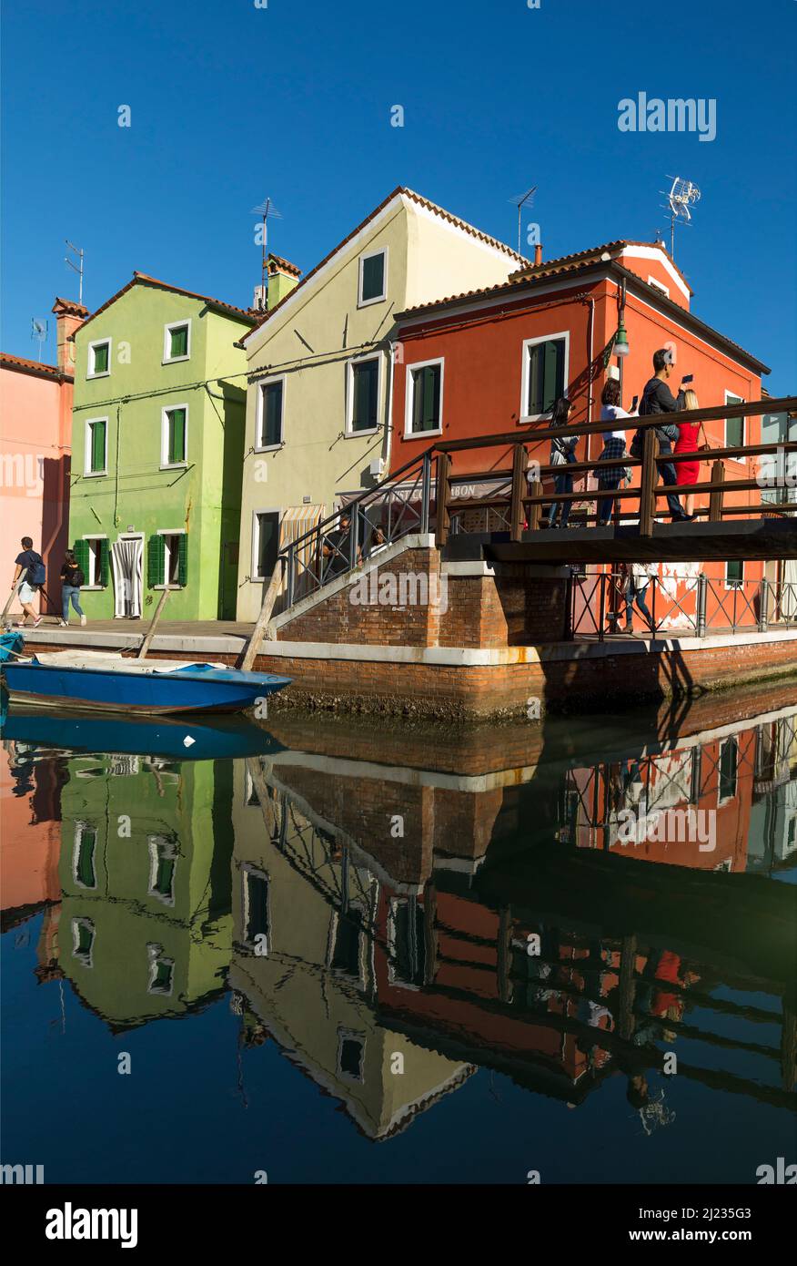 Italien, Venedig, bunte Häuser auf der venezianischen Insel Burano, mit Brücke und Spiegelung Stockfoto