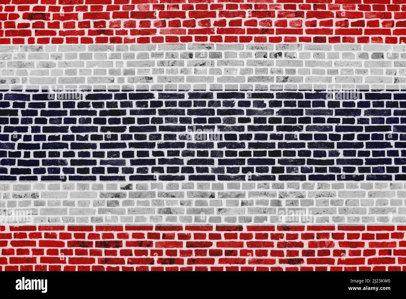 Nahaufnahme einer Ziegelmauer mit der Flagge Thailands. Stockfoto