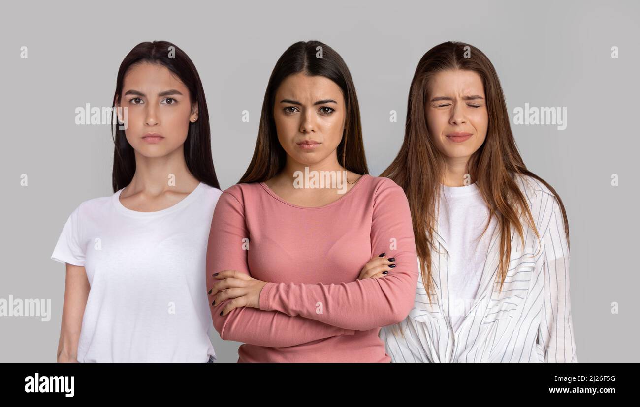 Porträt Von Drei Verärgerten Jungen Frauen, Die Isoliert Auf Grauem Hintergrund Stehen Stockfoto