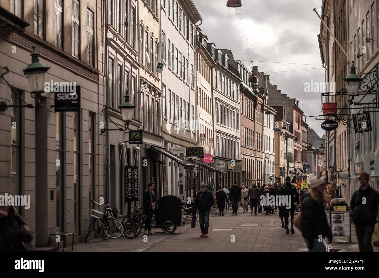 Dänen verbringen einen sonnigen Nachmittag mit Einkaufsmöglichkeiten und Restaurants in einem Einkaufsviertel in der Altstadt von Kopenhagen. Stockfoto