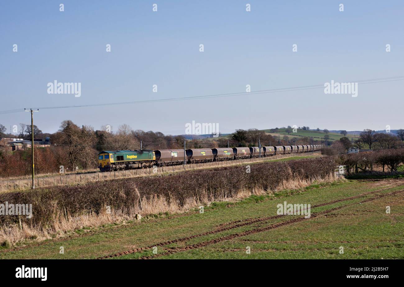 Freightliner Baureihe 66 Diesellokomotive 66514 mit leerem Karussell auf der elektrifizierten Hauptlinie der Westküste in Cumbria Stockfoto