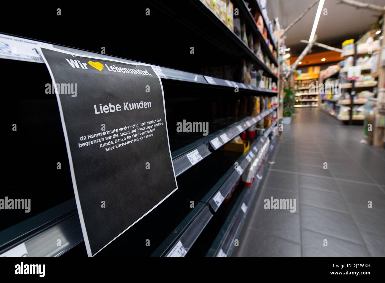 Neubiberg, Deutschland. 31. März 2022. In einem Supermarkt bleiben nur noch wenige Mehlpackungen auf einem Regal. Der Verkauf wurde aufgrund von Horten auf zwei Packungen pro Kunde beschränkt. Quelle: Sven Hoppe/dpa/Alamy Live News Stockfoto