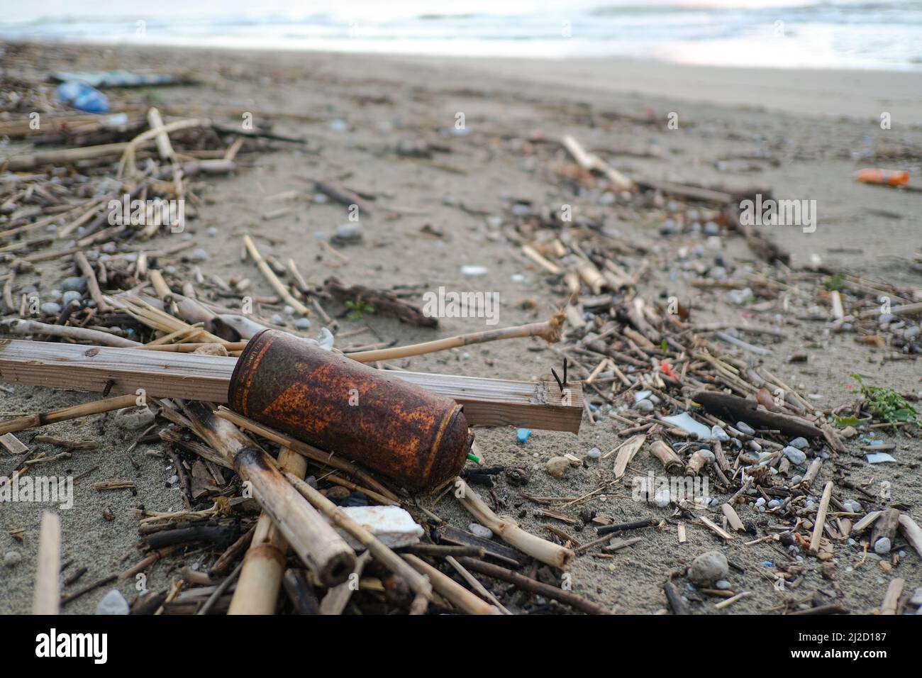 Altes verrosttes Spray kann auf dem Meeresküsten-Ökosystem, Verschmutzung durch die Natur, weggeworfen werden Stockfoto