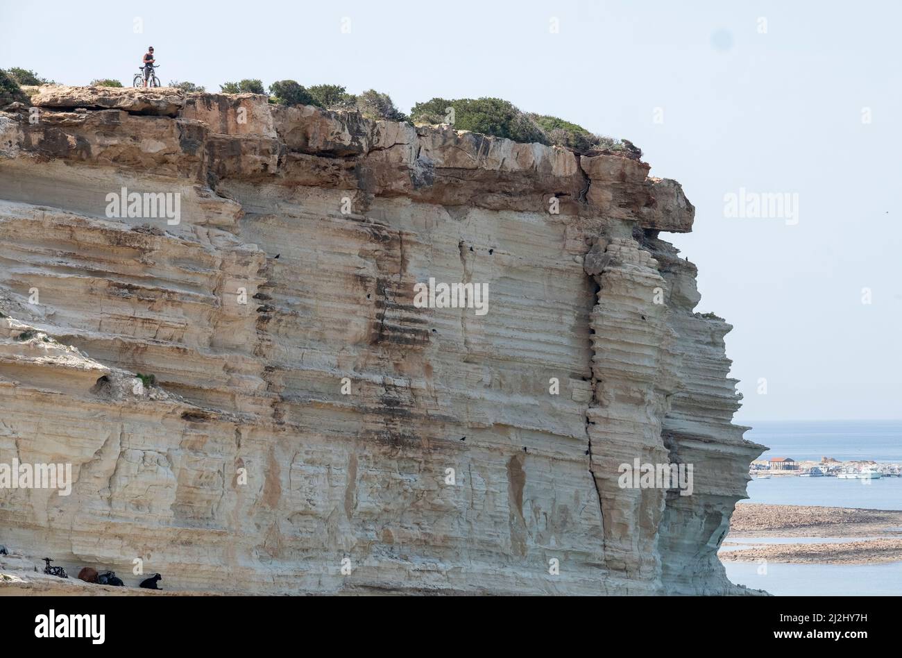 Von der Klippe der Avakas Bay im Akamas Peninsula National Park, Republik Zypern, blickt ein einmunder Radfahrer über das Meer. Stockfoto