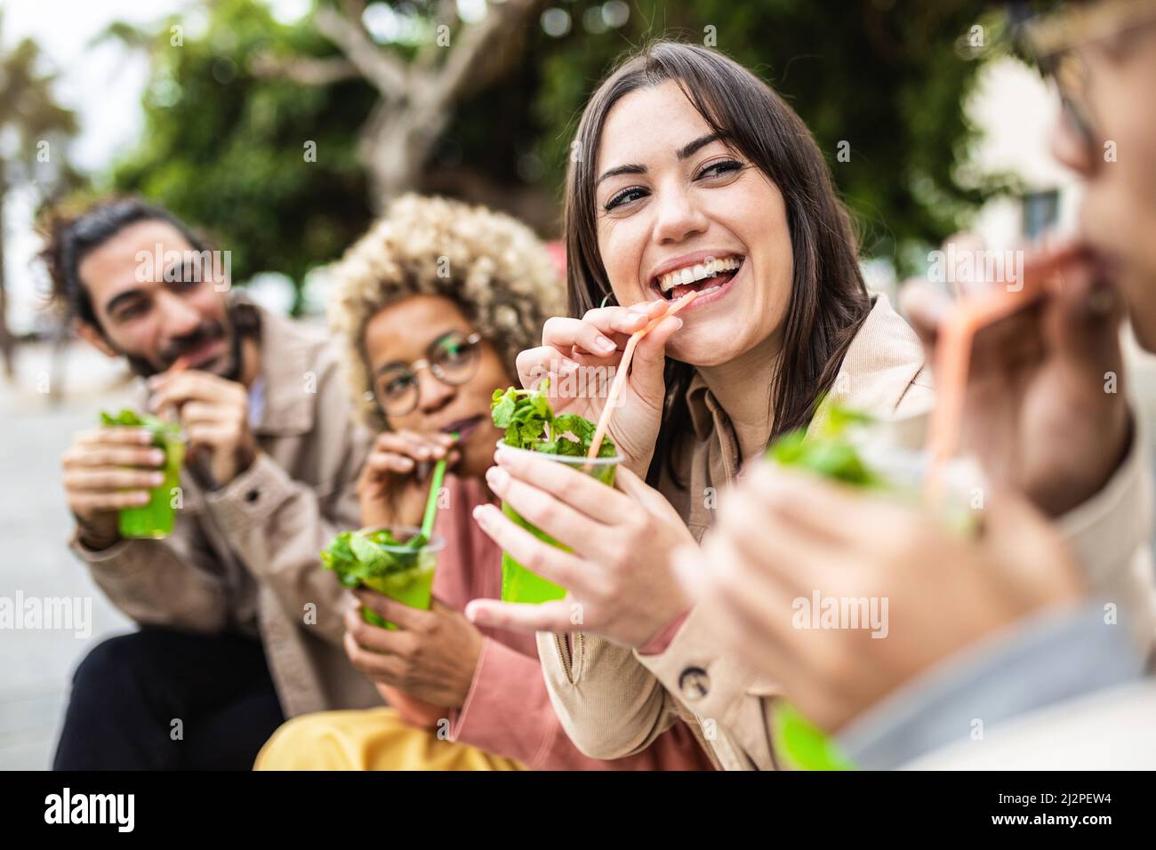 Millennials, die gemeinsam auf der Straße mit alkoholischen Getränken Spaß haben Stockfoto