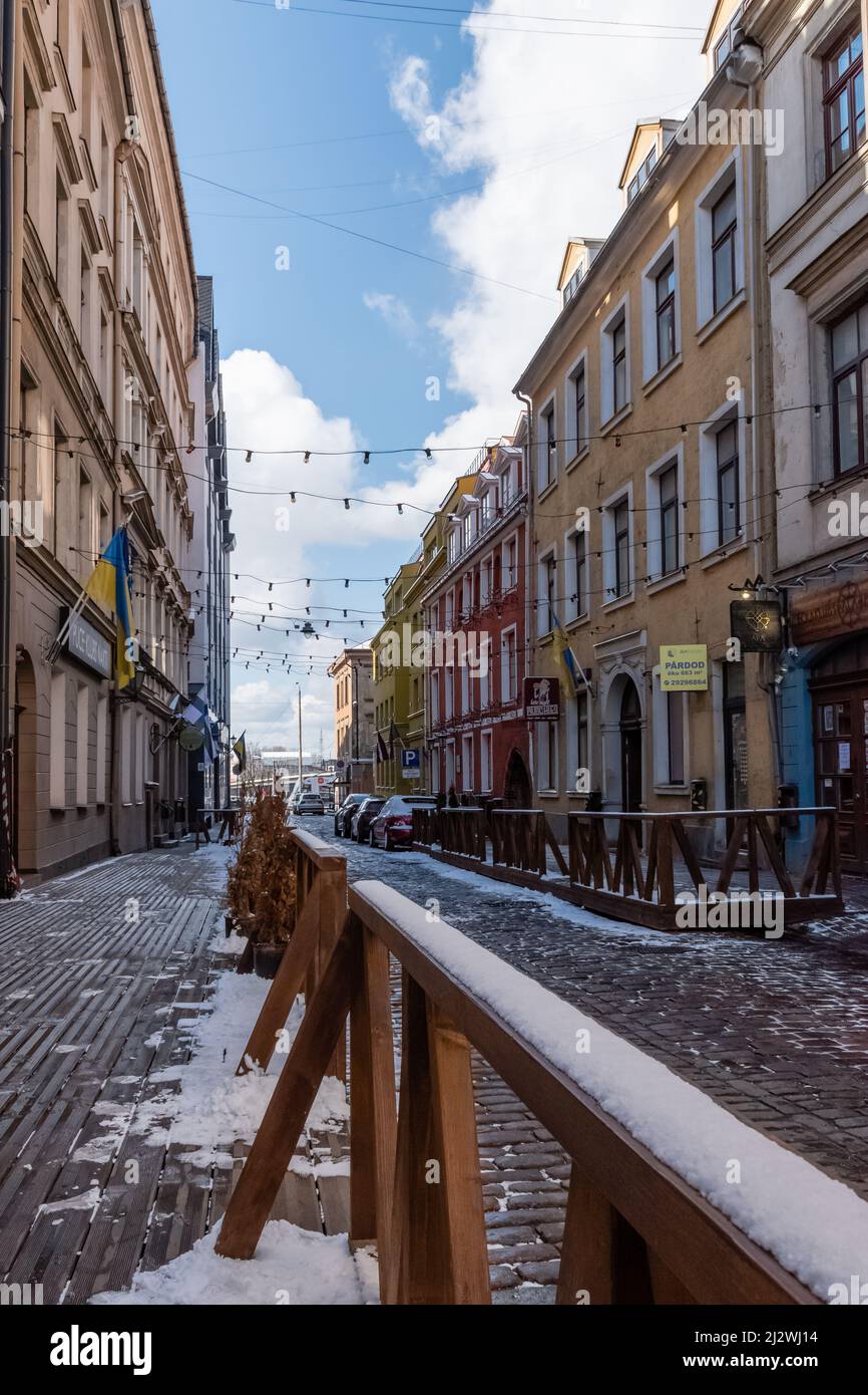 Eine Straße mit bunten Gebäuden in der Altstadt von Riga, Lettland, mit etwas Schnee auf dem Boden Stockfoto