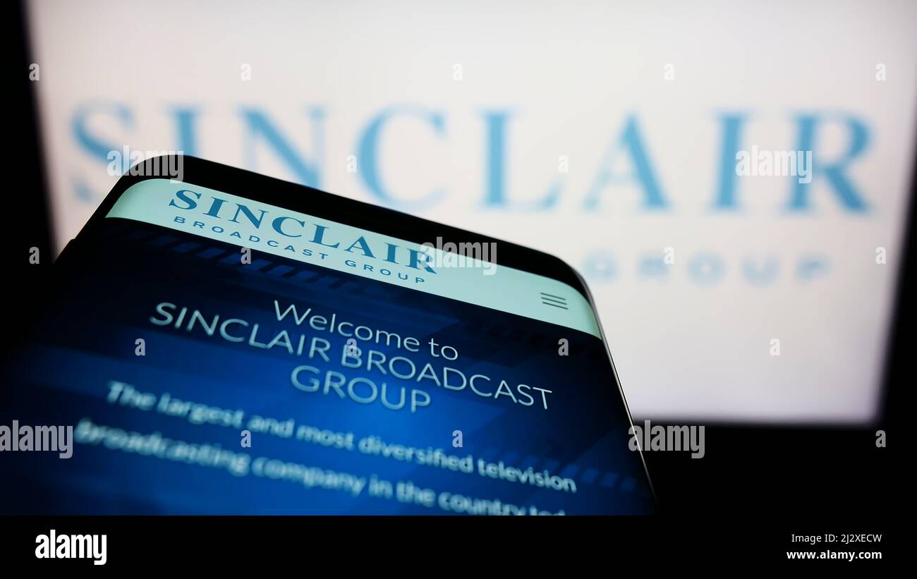 Smartphone mit Website der amerikanischen Firma Sinclair Broadcast Group Inc. (SBG) auf dem Bildschirm vor dem Logo. Konzentrieren Sie sich auf die obere linke Seite des Telefondisplays. Stockfoto