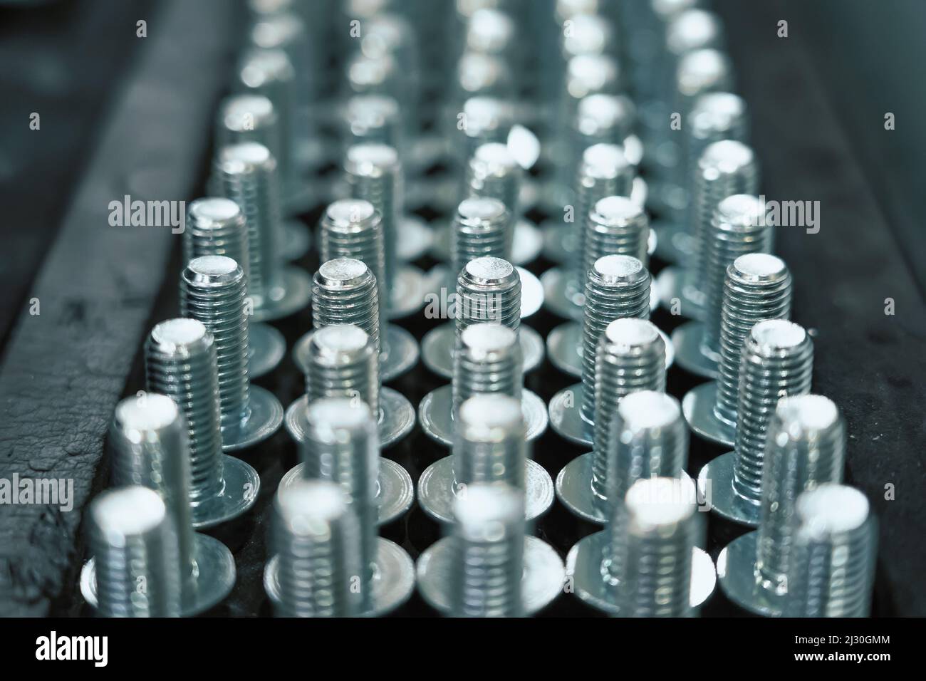 Viele Metallschrauben als Hintergrund für Industrieanlagen. Stockfoto