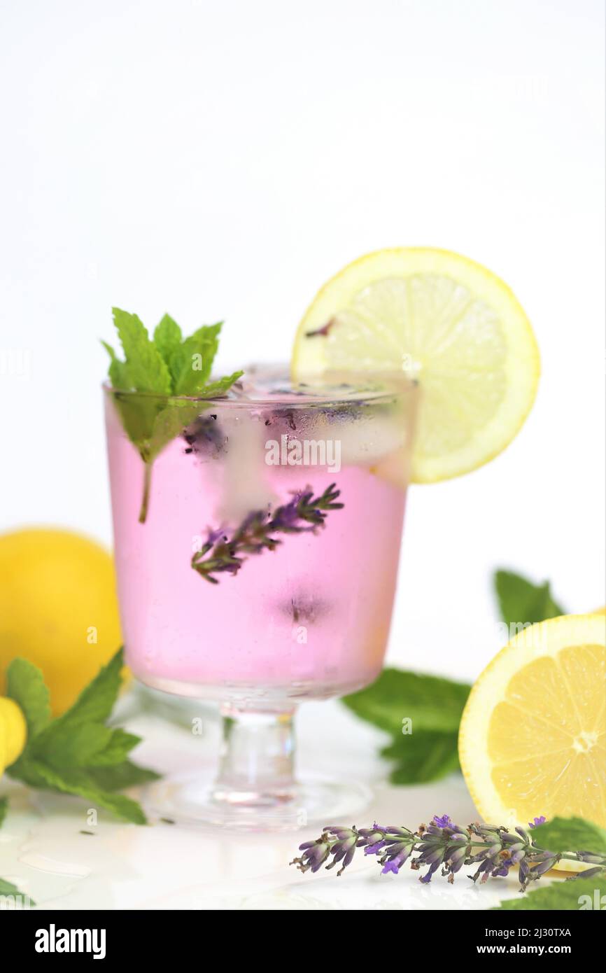 Lavendelcocktail in einem Glas.Sommergetränke. Lavendel Zitronengetränk. Lila Cocktail, Eis, Zitronen und Lavendelblüten. Stockfoto