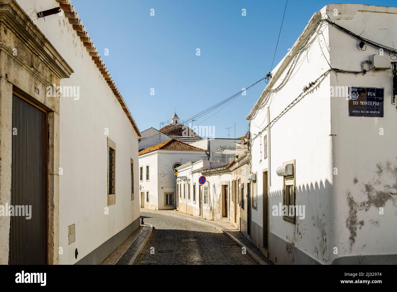 Schmale Straße mit weiß getünchten Gebäuden in der Innenstadt von Faro, Algarve, Portugal Stockfoto