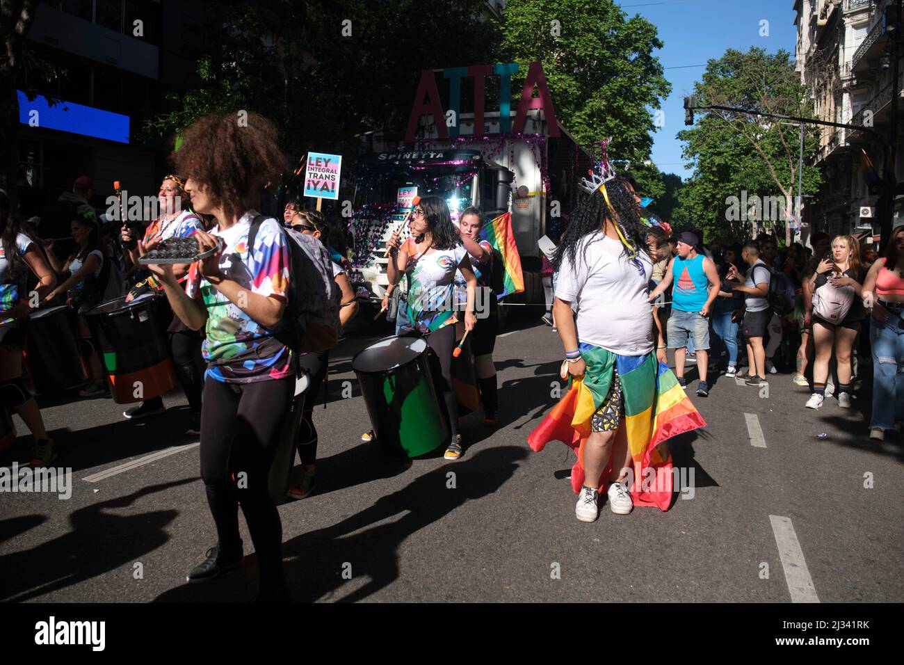 Buenos Aires, Argentinien; 6. November 2021: LGBT Pride Parade. Bunte Gruppe von Menschen marschieren und spielen Musik; Schild fordert die umfassende Trans l Stockfoto