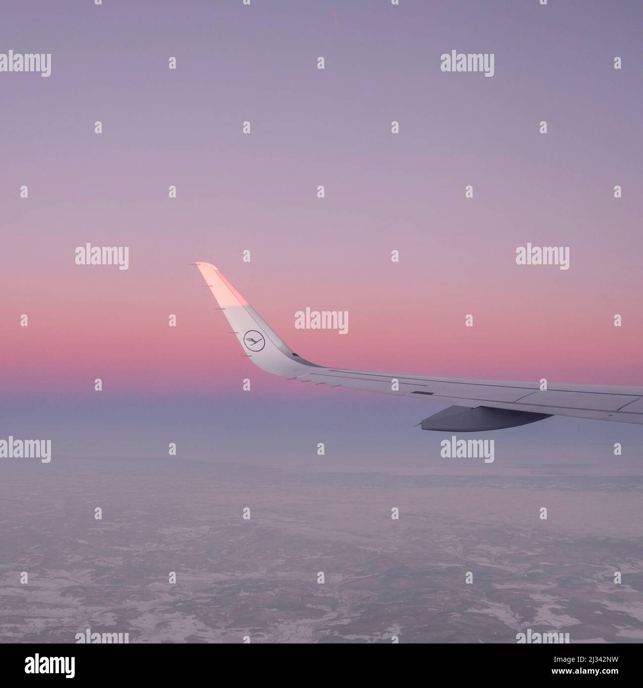 HAMBURG, DEUTSCHLAND - 19. JAN 2017: Strahlende Sonne am Flügel eines Lufthansa-Flugzeugs, das bei Sonnenaufgang fliegt Stockfoto