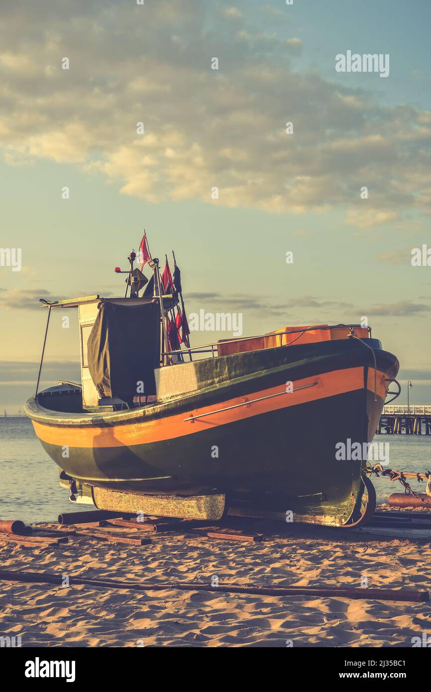 Schöner Morgenblick an der polnischen Küste in Gdynia. Schiff auf einem Sandstrand am Morgen. Stockfoto