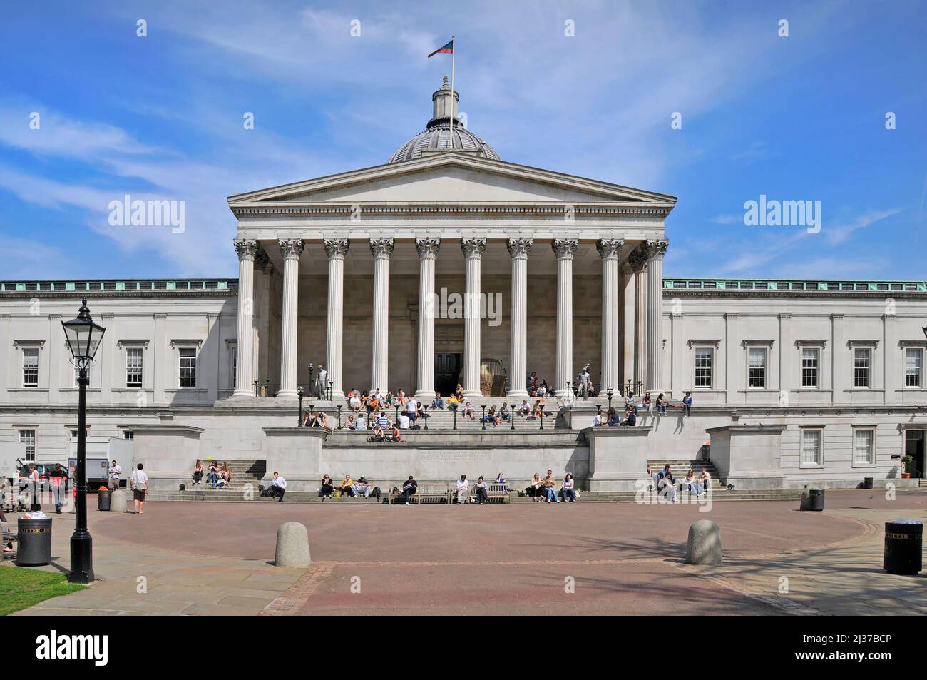 Gruppe von Studenten in der Ausbildung am historischen Wilkins Gebäude der UCL mit Säulengang Kolonnade auf dem Quad Campus University College London England Großbritannien Stockfoto