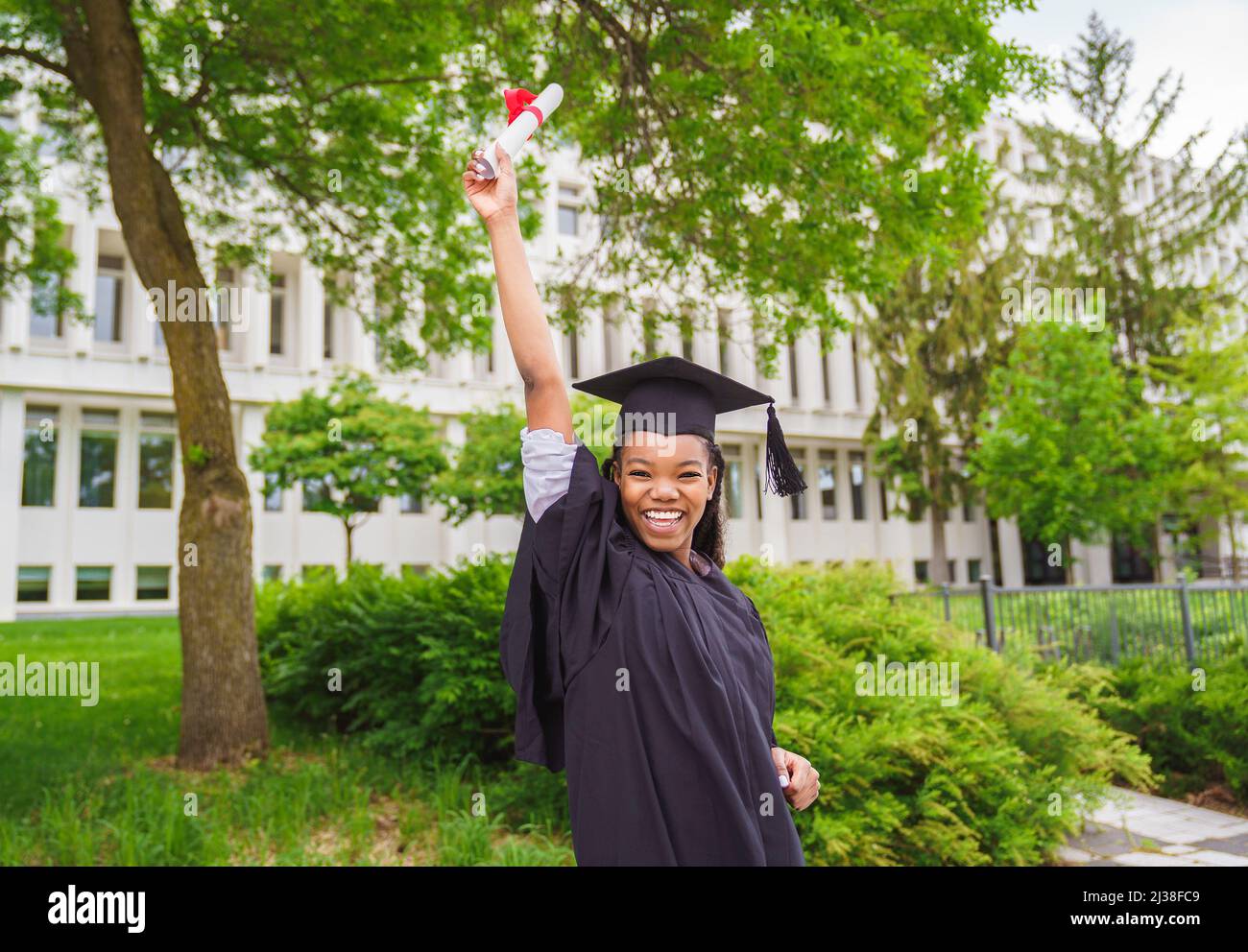 Glückliche afro amerikanische Hochschulabsolventen bei der Abschlussfeier Stockfoto