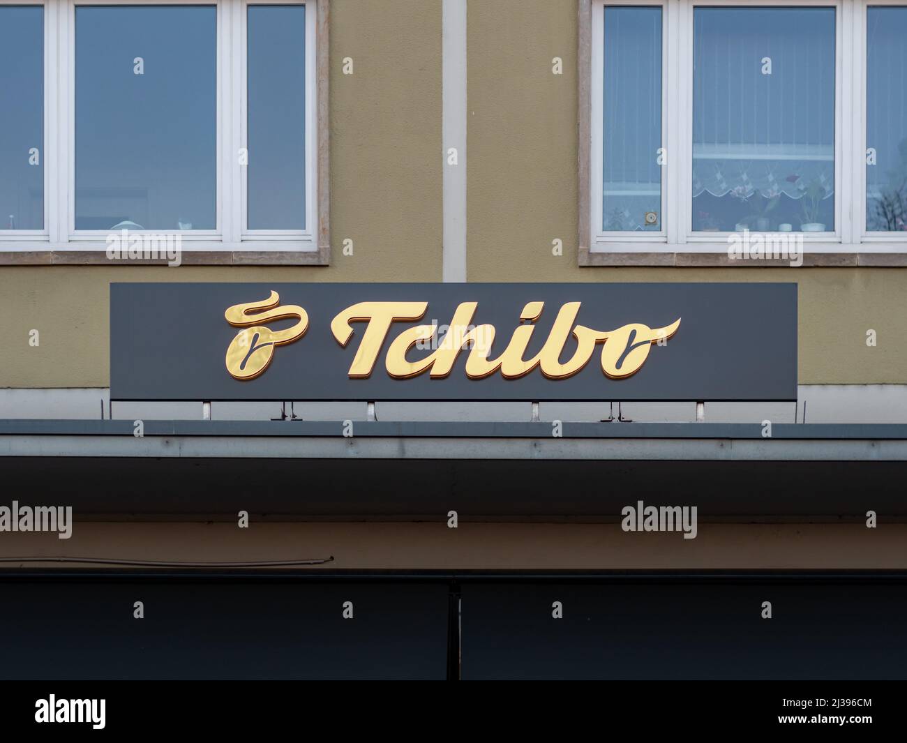 Tchibo-Logo vor der Gebäudefassade. Kette von Kaffeehäusern und Cafés. Das Unternehmen verkauft auch nicht-kaffeefreie Produkte. Catering-Service Stockfoto