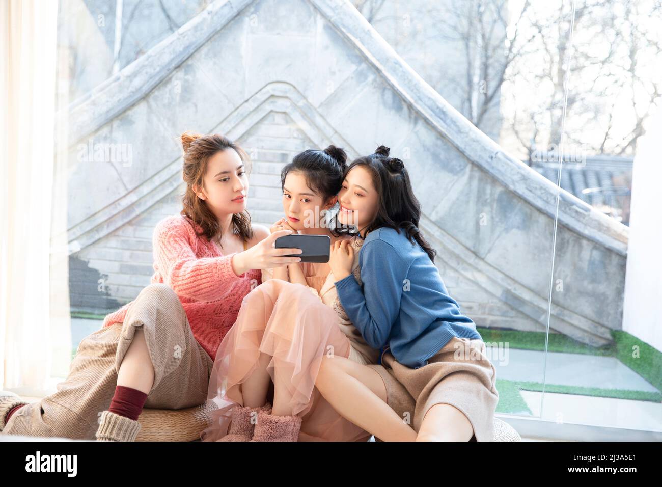 Chinesische schöne junge modische Damen Freizeit Treffen, mit Mobiltelefonen Unterhaltung Vielfalt zu sehen - Stock Foto Stockfoto
