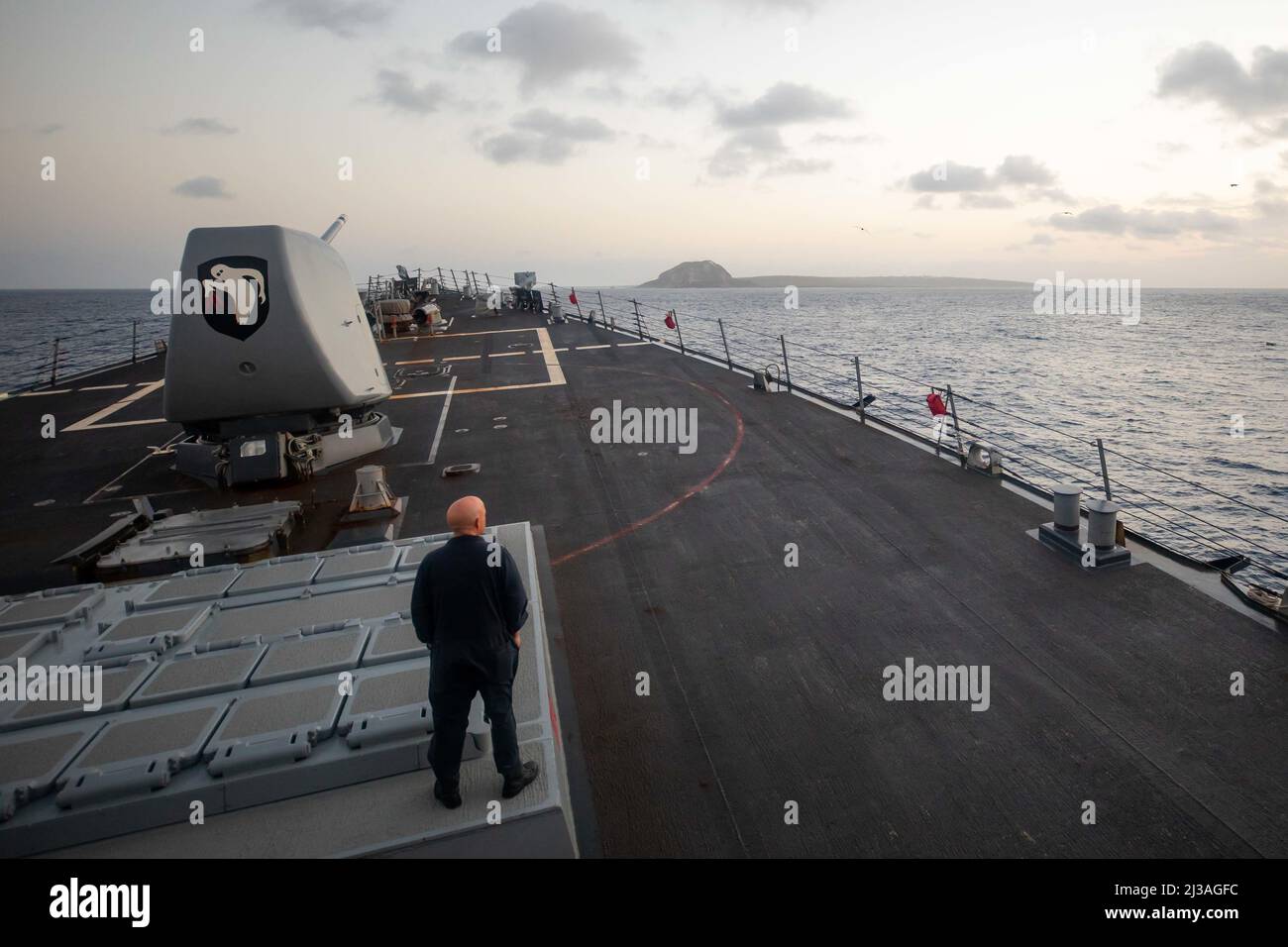 220403-N-KW492-1061 PHILIPPINE SEA (3. April 2022) Erik Kuntzleman aus Las Vegas, Senior Chief Fire Controlman, beobachtet, wie der Lenkraketen-Zerstörer USS Milius (DDG 69) der Arleigh Burke-Klasse an Iwo vorbei reist. Japan, das früher als Iwo Jima bezeichnet wurde, kehrte 2007 zurück, um es unter seinem Vorkriegsnamen zu nennen. Milius ist dem Destroyer Squadron (DESRON) 15, dem größten vorwärtseingesetzten DESRON der Marine und der wichtigsten Kampftruppe der US-7.-Flotte, zugewiesen und unterstützt derzeit einen freien und offenen Indo-Pazifik-Raum. (USA Navy Foto von Mass Communication Specialist 2. Class Ryre Arciaga) Stockfoto