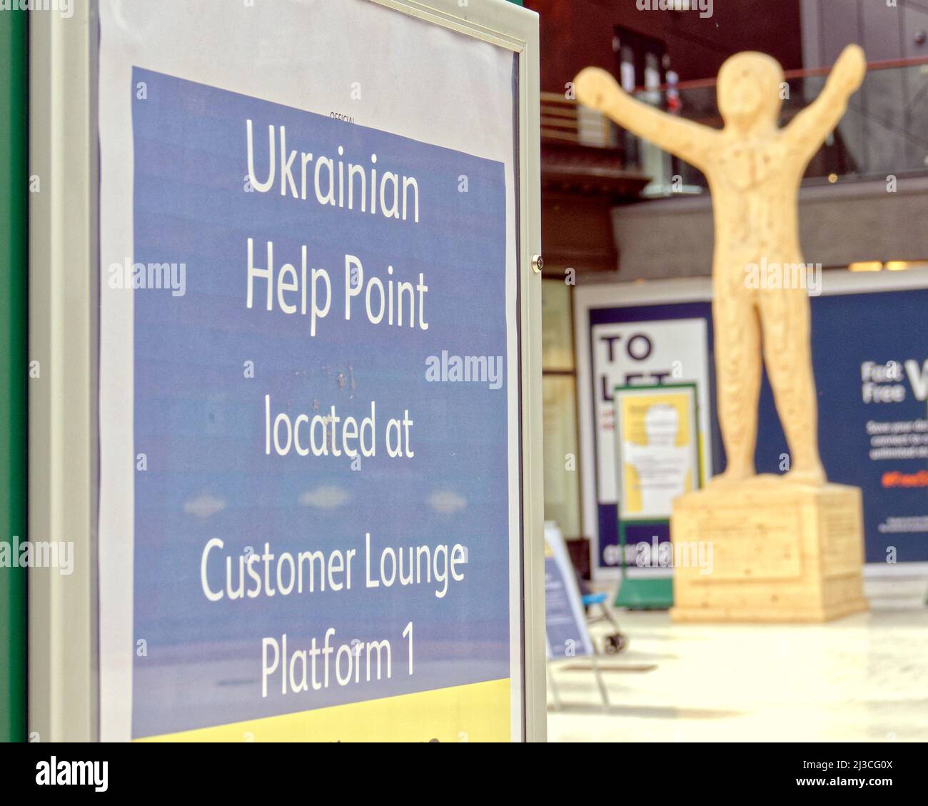 Glasgow, Schottland, Großbritannien 7.. April 2022. Der Hauptbahnhof hat es ukrainischen Flüchtlingen leicht gemacht, zu reisen, indem er das kostenlose Reiseprogramm auf Plakaten überall auf dem Bahnhof hervorhob. Die Statue des Leuchtturmes der Hoffnung von stewart Padwick befindet sich in der Bahnhofskonkurie mit ihren einladenden Händen. Credit Gerard Ferry/Alamy Live News Stockfoto