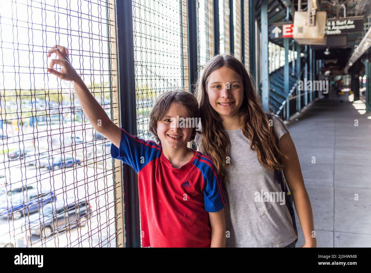 CONEY ISLAND, New York City, NY, USA, 14 Jahre altes kaukasisches Teenager-Mädchen und 12 Jahre altes kaukasisches Teenager-Mädchen – beide mit braunen Haaren und sommerlichem Styling an der U-Bahn-Station Stockfoto