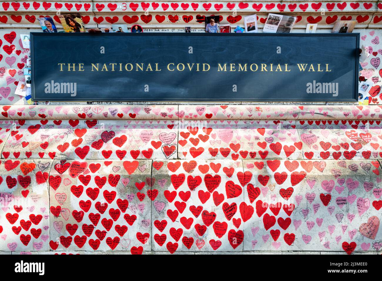 London, Großbritannien - 26. März 2022: Detail der National Covid Memorial Wall, Southbank. Handgezeichnete Herzen mit Botschaften und Fotos von Angehörigen, die an CO verloren gegangen sind Stockfoto