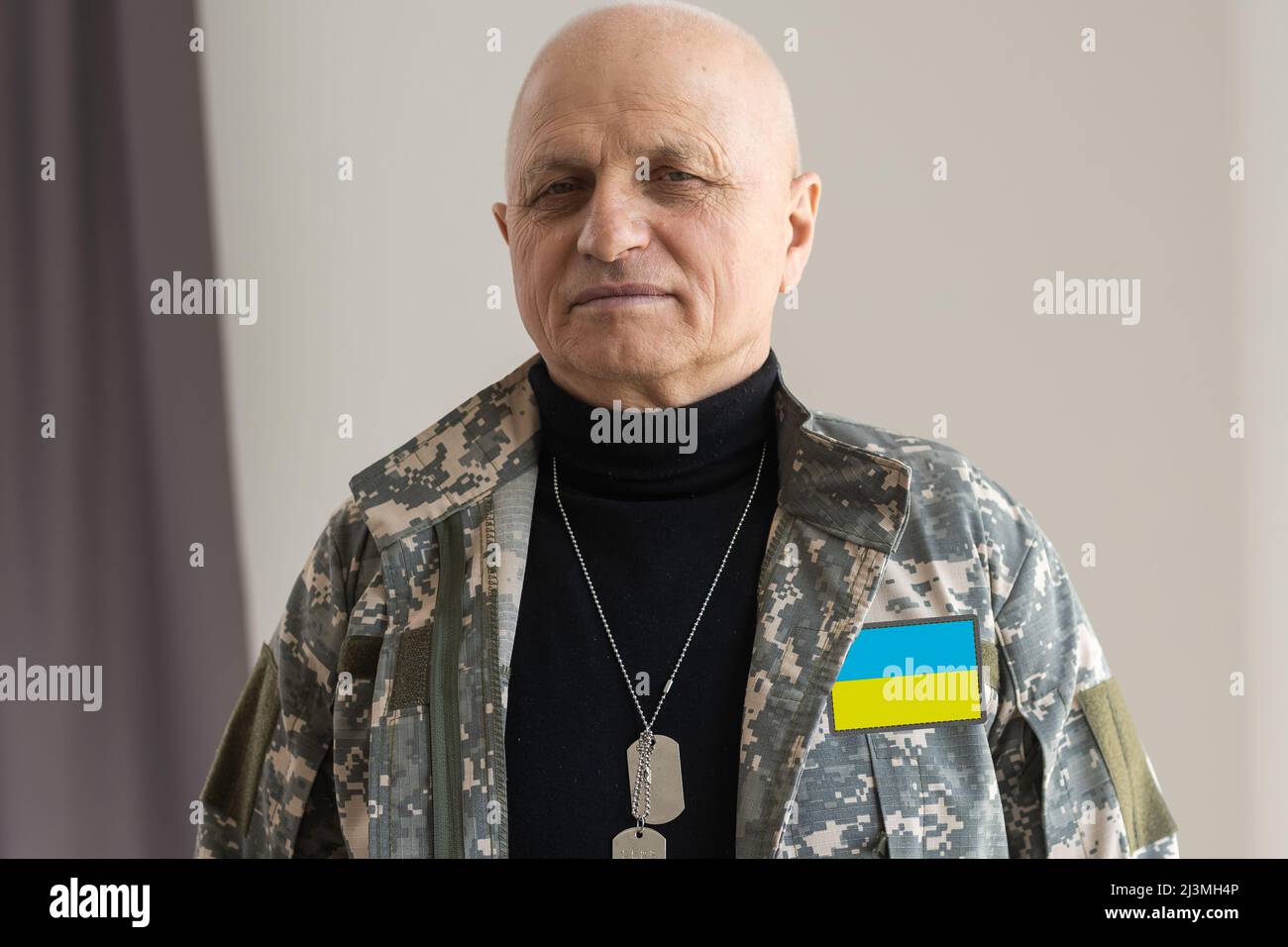Ukrainischer Mann Krieger in einem militärischen Pixel Uniform die gelb-blaue Flagge der Ukraine gekleidet Stockfoto