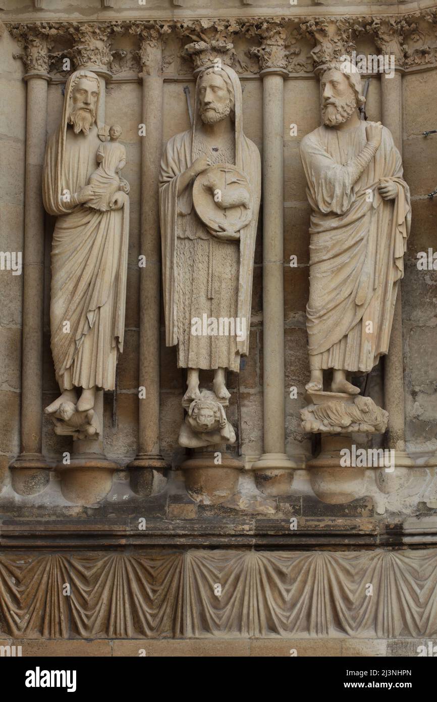 Der heilige Simeon, der heilige Johannes der Täufer, der Prophet Jesaja, dargestellt von links nach rechts auf dem Südportal der Westfassade der Kathedrale von Reims (Cathédrale Notre-Dame de Reims) in Reims, Frankreich. Gotische Statuen auf der rechten Seite des Südportals wurden vor 1220 datiert. Stockfoto