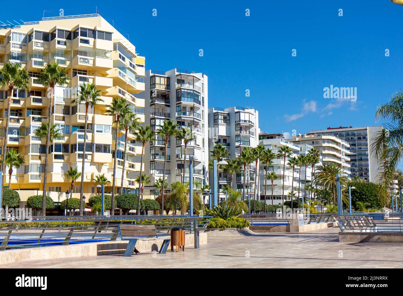 Marbella Stadtpromenade in der Nähe der Stadtbucht. Leeres Quadrat. Im Hintergrund Marbella Häuser am Strand, Luxus und teure Immobilien. Stockfoto