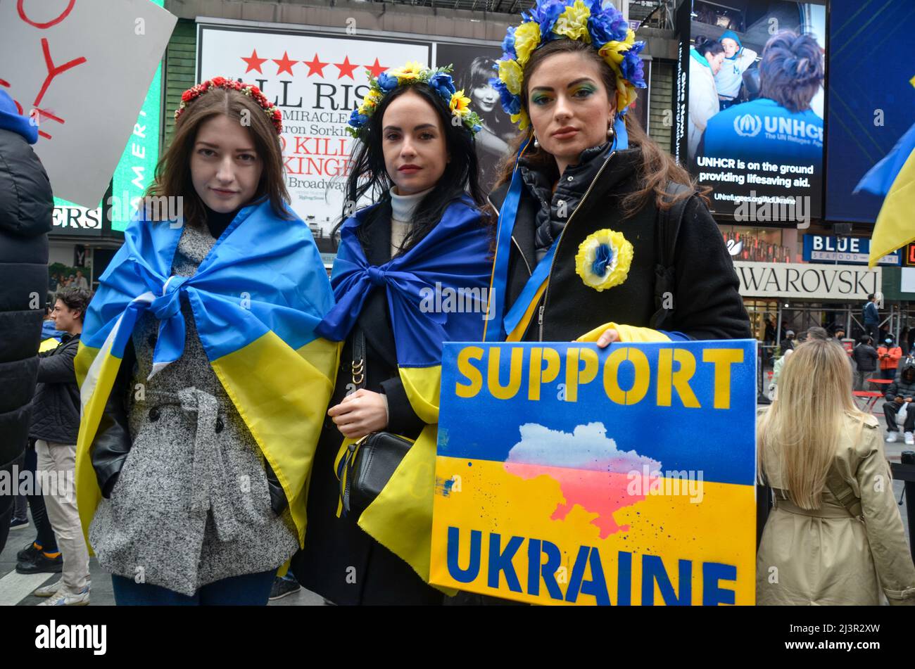 Demonstranten, die blau und gelb (ukrainische Flagge) trugen, um am 09. April 2022 auf dem Times Square in New York City Solidarität mit der Ukraine zu zeigen. Stockfoto