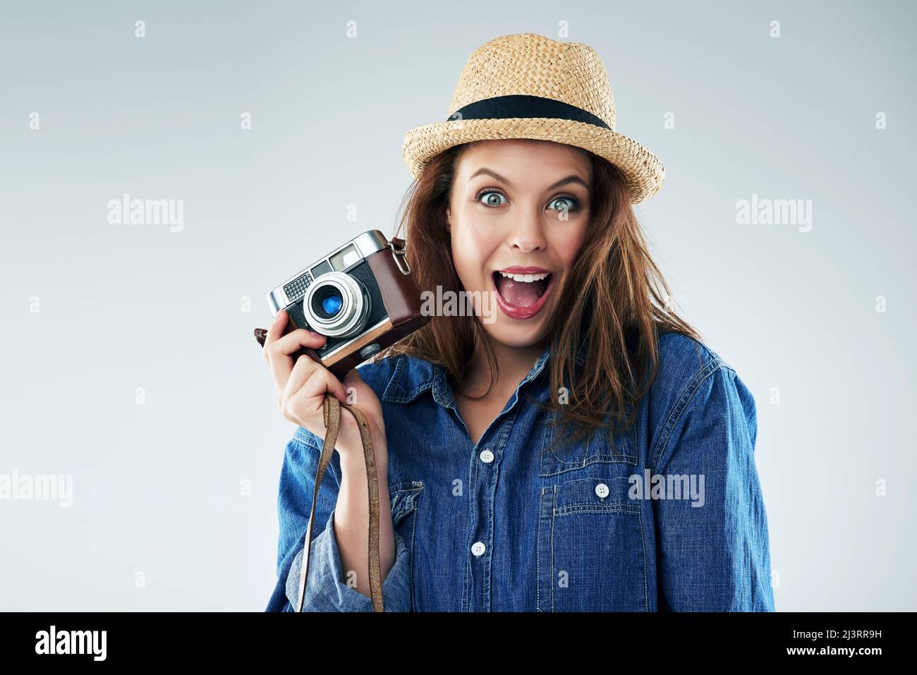Ich kann mir keinen aufregenderen Moment vorstellen. Studioportrait einer jungen Frau mit einer Vintage-Kamera vor grauem Hintergrund. Stockfoto Ich kann mir keinen aufregenderen Moment vorstellen. Studioportrait einer jungen Frau mit einer Vintage-Kamera vor grauem Hintergrund. Stockfoto