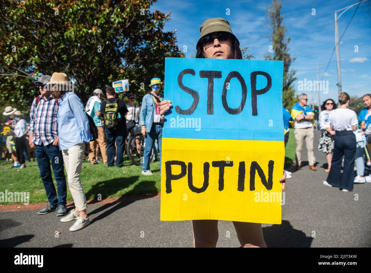 Melbourne, Australien. 10. April 2022. Eine Frau hält ein Schild mit der Aufschrift „Stoppt Putin“ bei einer Kundgebung für den Frieden in der Ukraine in Melbourne. Quelle: Jay Kogler/Alamy Live News Stockfoto