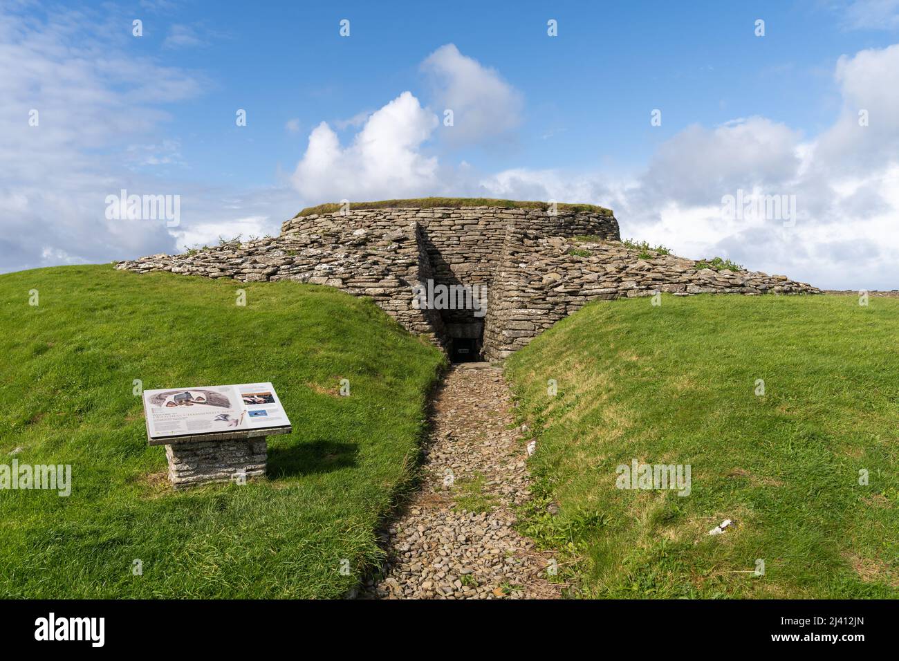 Der Eingang und die Touristeninformation in Quoyness Chambered Cairn auf Sanday, einem neolithischen Ort von großer Bedeutung auf den Orkney Isles, Schottland. Stockfoto
