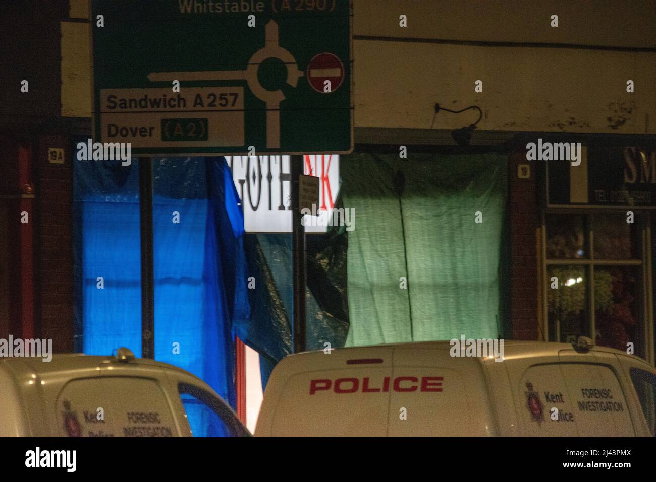 Canterbury, Großbritannien. 11.. April 2022. Die Polizei von Kent wurde heute in ein Gebäude in der Lower Bridge St, Canterbury, gerufen, um auf Berichte von zwei Personen zu reagieren, die Verletzungen erlitten hatten. An diesem Abend waren noch Straßensperrungen vorhanden, und Gerichtsbeamte und Spezialbeamte waren noch am Tatoort von Gothink und im Piercing-Studio. Quelle: graham mitchell/Alamy Live News Stockfoto