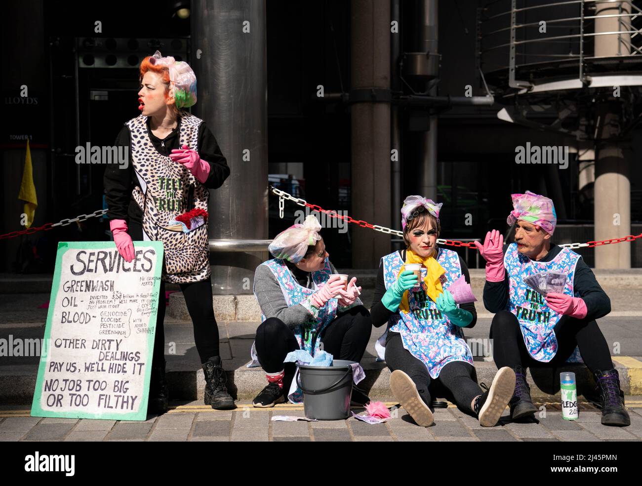 Aktivisten des Extinction Rebellion, die als Reinigungskräfte außerhalb von Lloyds of London in der City of London gekleidet sind, fordern Lloyds auf, die Versicherung von Projekten für fossile Brennstoffe weltweit einzustellen. Bilddatum: Dienstag, 12. April 2022. Stockfoto