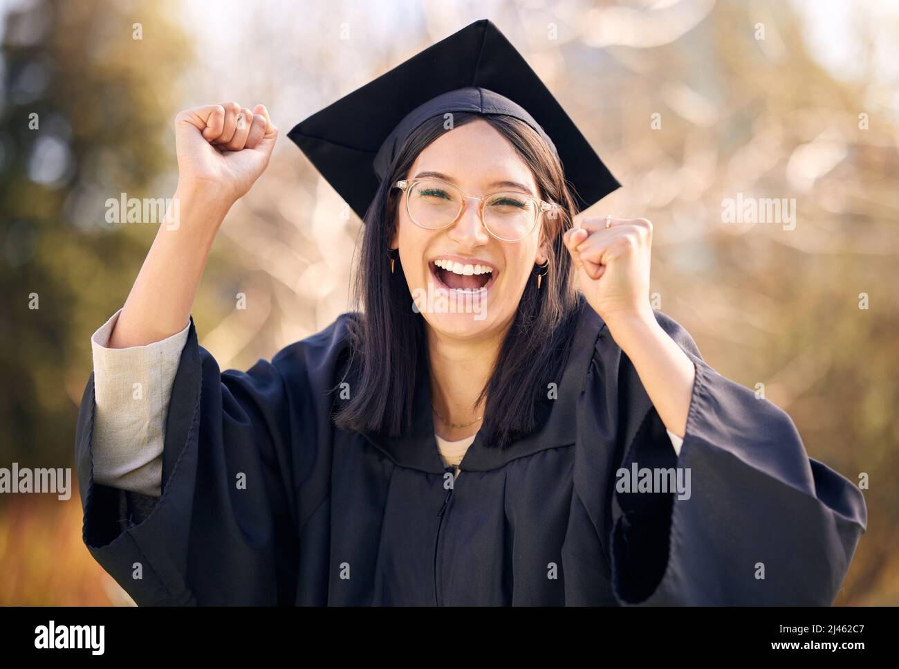 Ich kam, ich lernte, ich eroberte. Aufnahme einer jungen Frau, die am Abschlusstag jubelt. Stockfoto