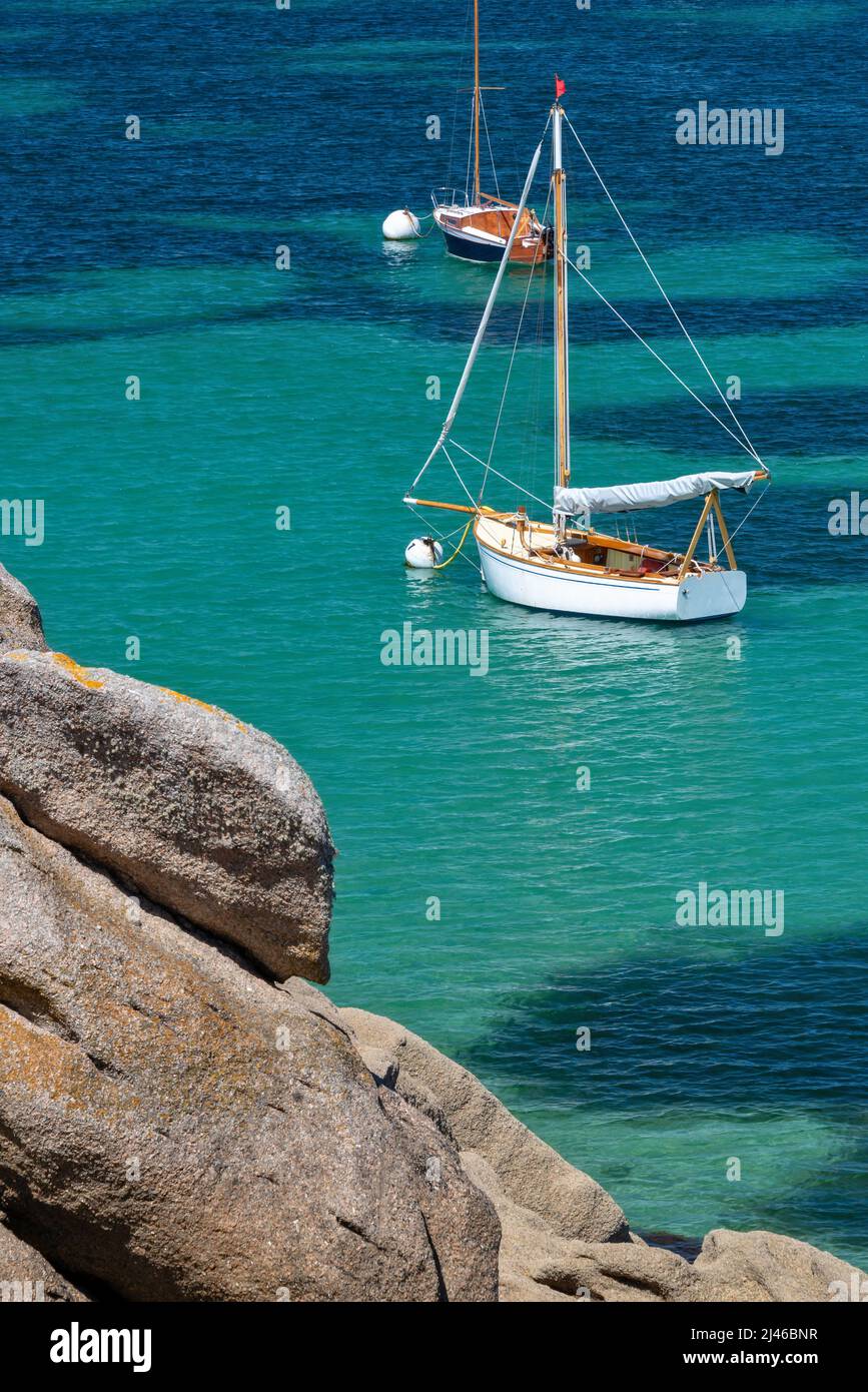 Segelboote und transparentes Wasser am Strand von Coz-Pors in Tregastel, Côtes d'Armor, Bretagne, Frankreich Stockfoto