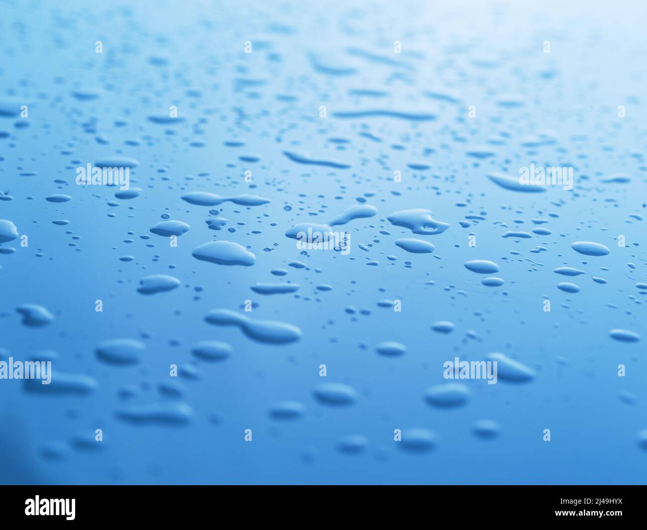 Es gibt überall Spuren von Wasser. Abstrakte Studioaufnahme von Wassertropfen auf einer blauen Oberfläche. Stockfoto