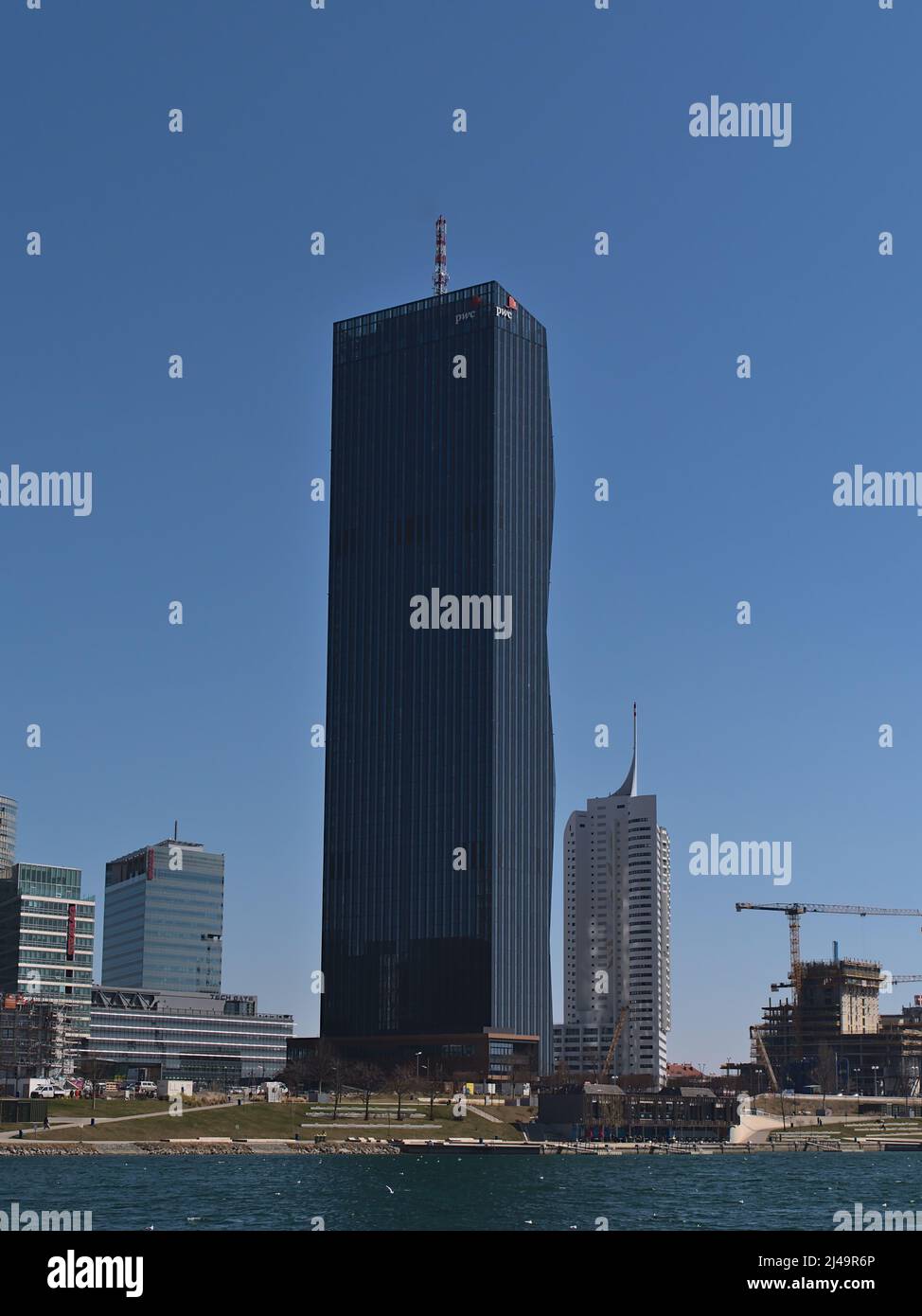 Blick auf den Wolkenkratzer DC Tower 1 (220 m) in der Donau City im Norden von Wien, Österreich, am Donauufer an sonnigen Frühlingstag. Stockfoto