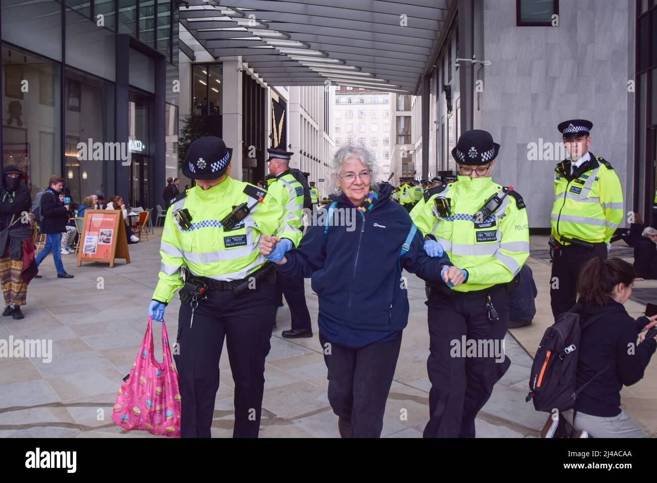 London, Großbritannien. 13.. April 2022. Polizisten verhaften einen Protestierenden. Aktivisten des Extinction Rebellion verursachten Chaos im Londoner Hauptquartier des Ölgiganten Shell, wobei sich Dutzende von Demonstranten vor dem Eingang am Boden und mehrere im Gebäude klebten. Kredit: Vuk Valcic/Alamy Live Nachrichten Stockfoto