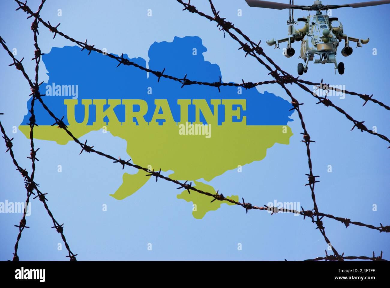 Krieg in der Ukraine, Stacheldraht, ukrainische Flagge, Angriff auf die Ukraine mit russischen Hubschraubern. Bedrohung für Europa Stockfoto