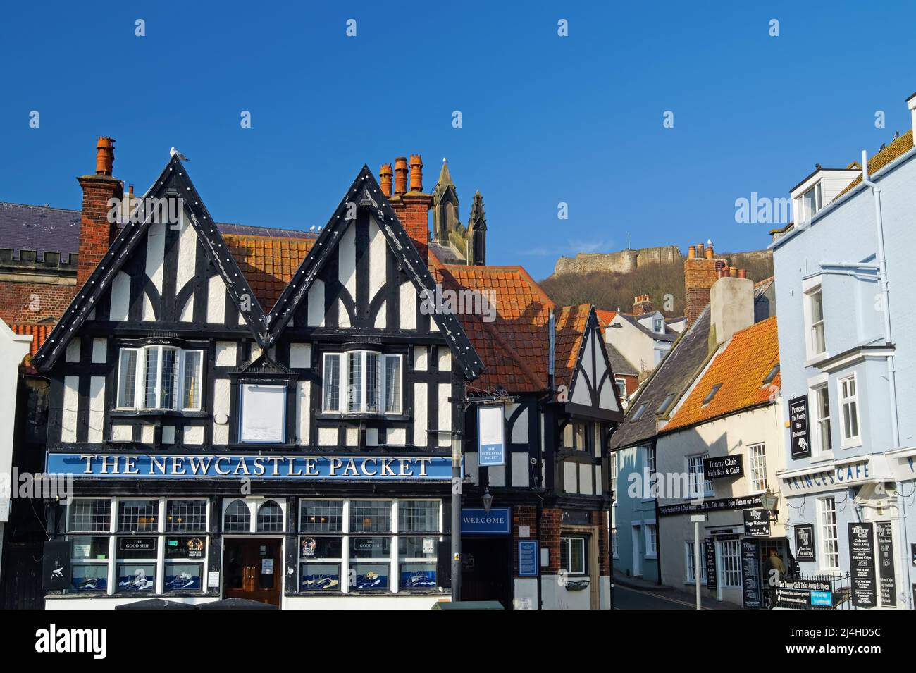 Großbritannien, North Yorkshire, Scarborough, Sandside, der Newcastle Packet Pub mit Blick auf East Sandgate zum Schloss. Stockfoto